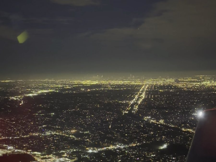 City lights at night from the cockpit of a training aircraft.