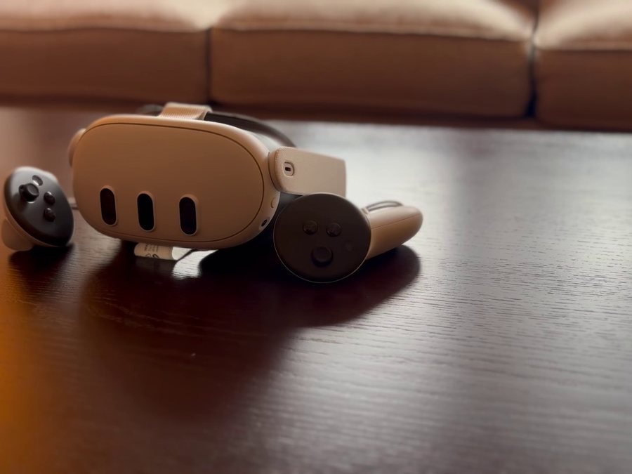 A VR headset and controllers on a table at home.